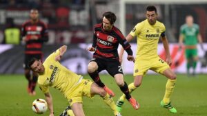 "LEVERKUSEN, GERMANY - MARCH 17: Antonio Rukavina of Villarreal challenges Robbie Kruse of Bayer Leverkusen during the UEFA Europa League round of 16, second leg match between Bayer Leverkusen and Villarreal CF at Bay Arena on March 17, 2016 in Leverkusen, Germany. (Photo by Dennis Grombkowski/Bongarts/Getty Images)"
