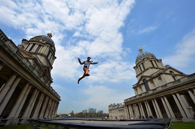 Trampolinist Max Calaf performs in the grounds of the Royal Naval College, Greenwich, London to help promote the Greenwich + Docklands International Festival taking place in June. 7/05/2013