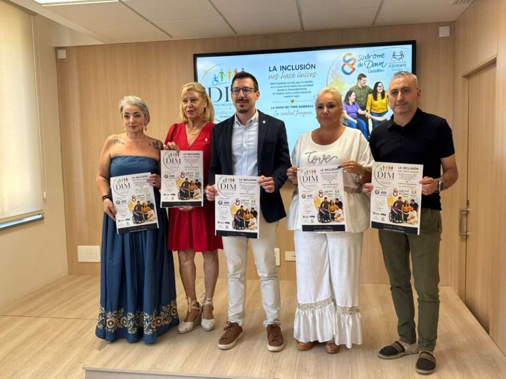 Five adults stand in a room, each holding a flyer for an event, posing for a group photo in front of a presentation screen and wooden walls.