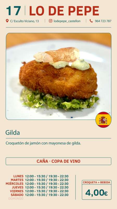Plate with a breaded ham croquette topped with pale green mayo on a bed of chopped greens; part of a restaurant menu (Gilda) with a small Spanish flag badge.