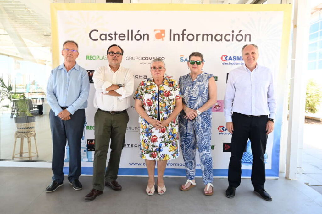 Five people pose in front of a Castellón Información banner at a sponsorship event indoors.