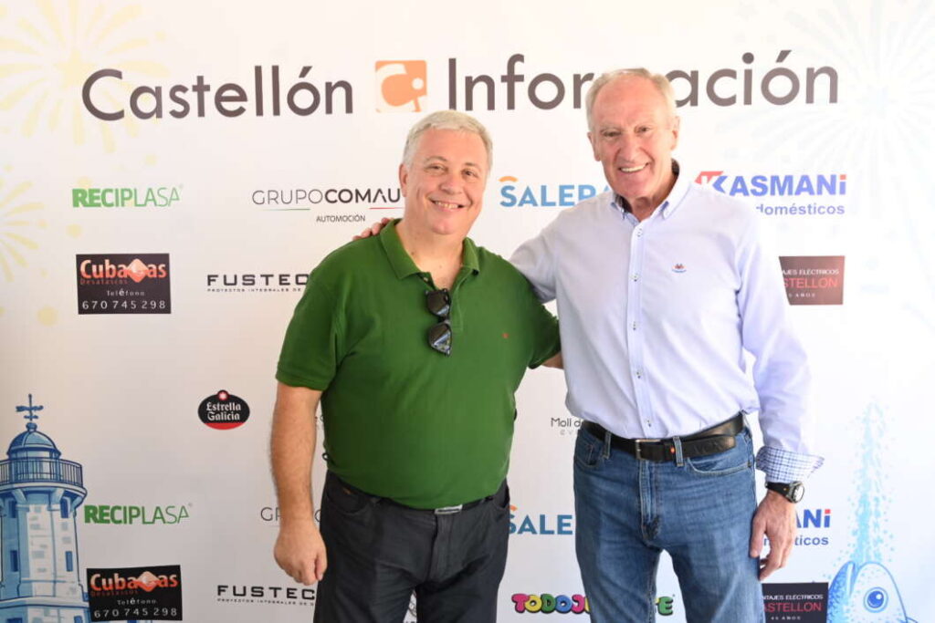 Two men posing for a photo at a Castellón Información event, smiling, with sponsor logos on the backdrop behind them.