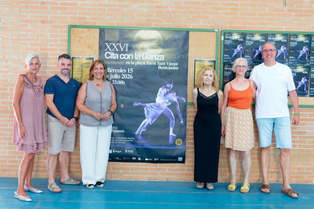 Six adults standing in a row indoors, posing in front of a large dance poster on a brick wall.