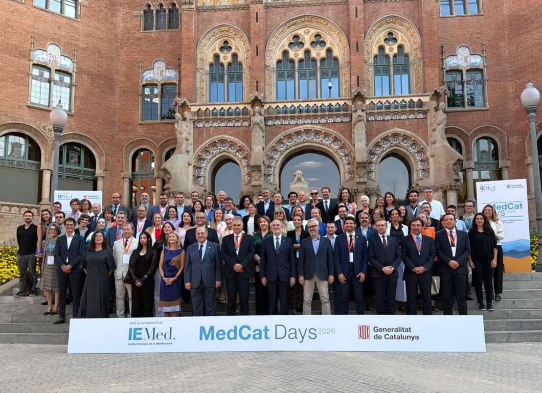 Group of professionals posing on steps in front of an ornate red-brick building during MedCat Days 2026, with a banner reading 'MedCat Days 2026' and 'Generalitat de Catalunya' in the foreground.