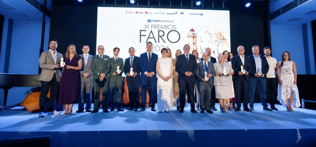Group of award recipients on stage at the XI Premios FARO 2020 ceremony, each holding a trophy, with a large event logo screen behind them on a blue-lit stage.